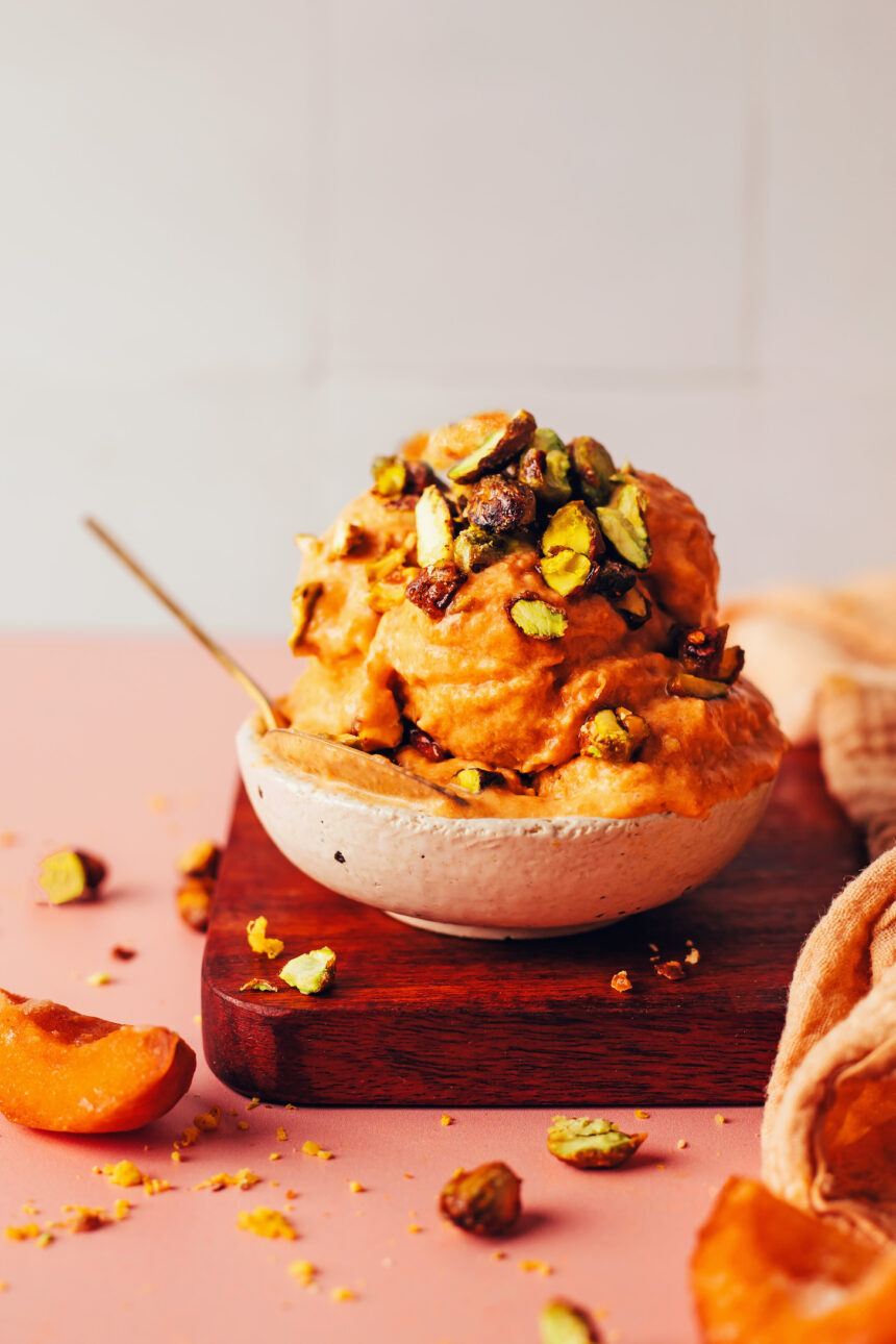 Bowl with scoops of vegan apricot sorbet topped with candied pistachios