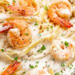 Close up overhead view of shrimp Alfredo in a bowl.