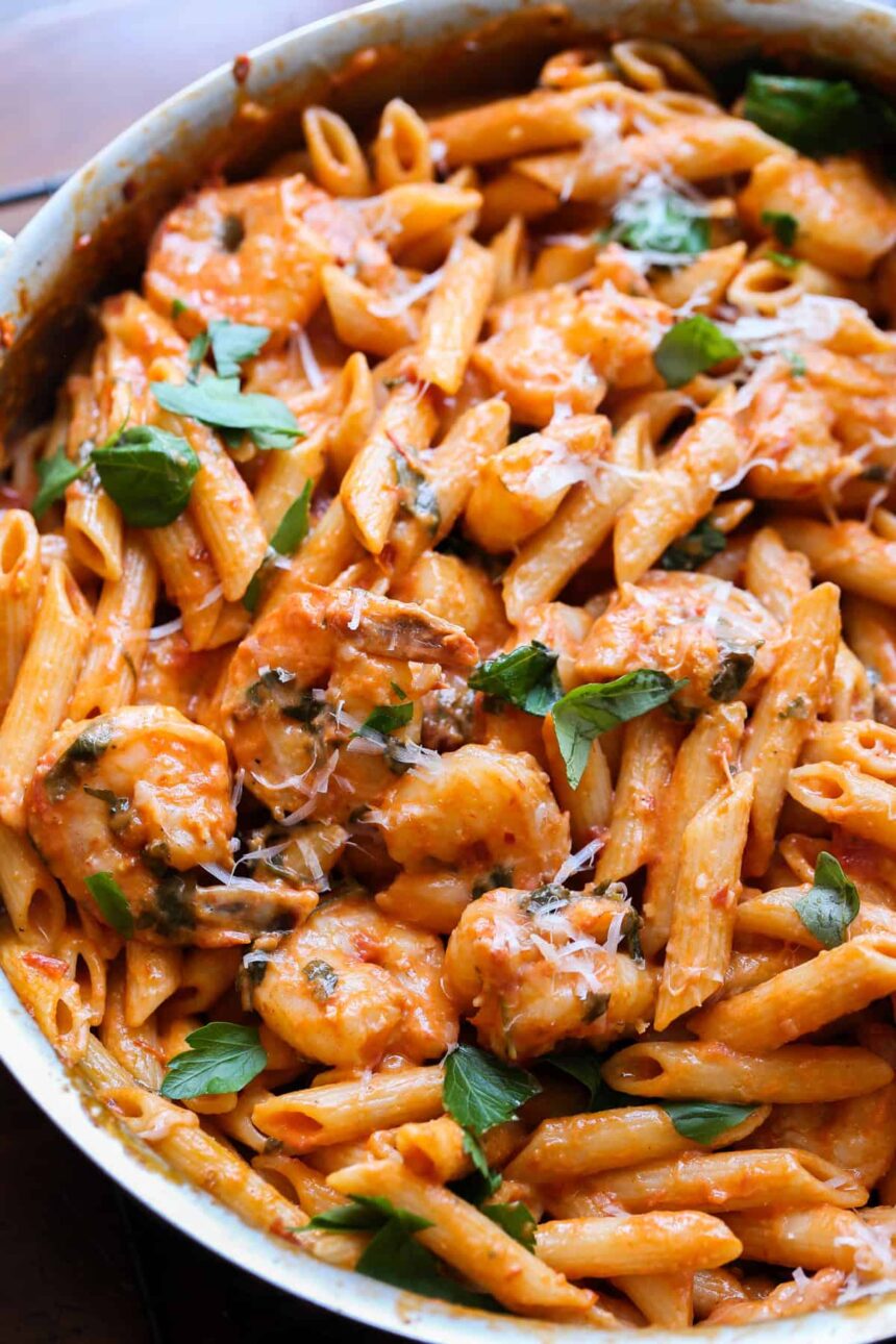 Creamy Shrimp Pasta in a large skillet with a fresh basil garnish