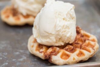 Cinnamon Roll waffle with a scoop of ice cream on it.