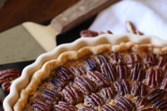 A Pecan Tart in a red ceramic tart pan