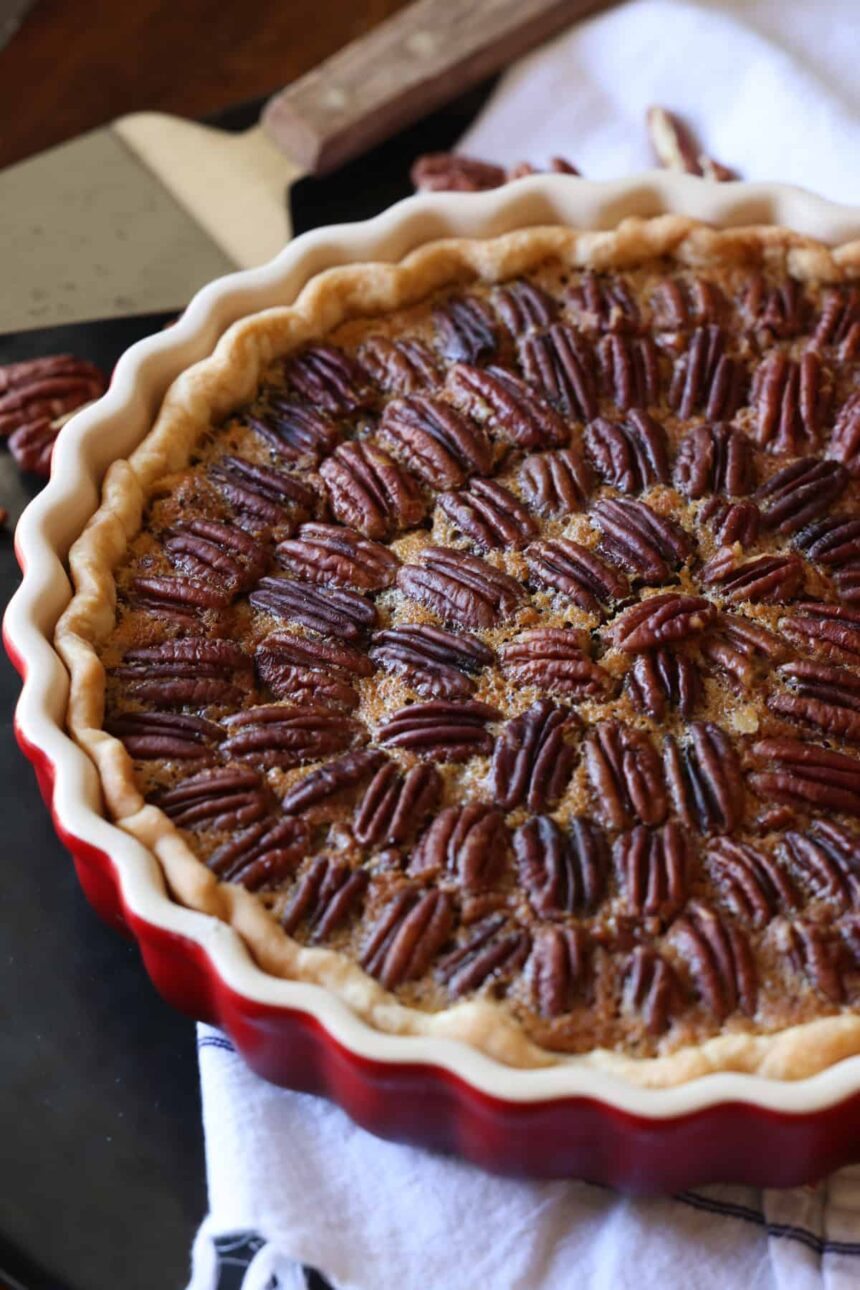 A Pecan Tart in a red ceramic tart pan