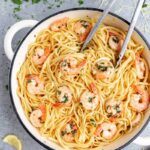 Looking into a large pot filled with shrimp linguine.