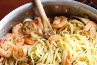 Shrimp scampi in a pan with linguine.