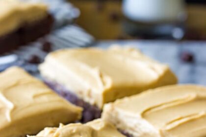 Brownies cut into squares, topped with peanut butter frosting