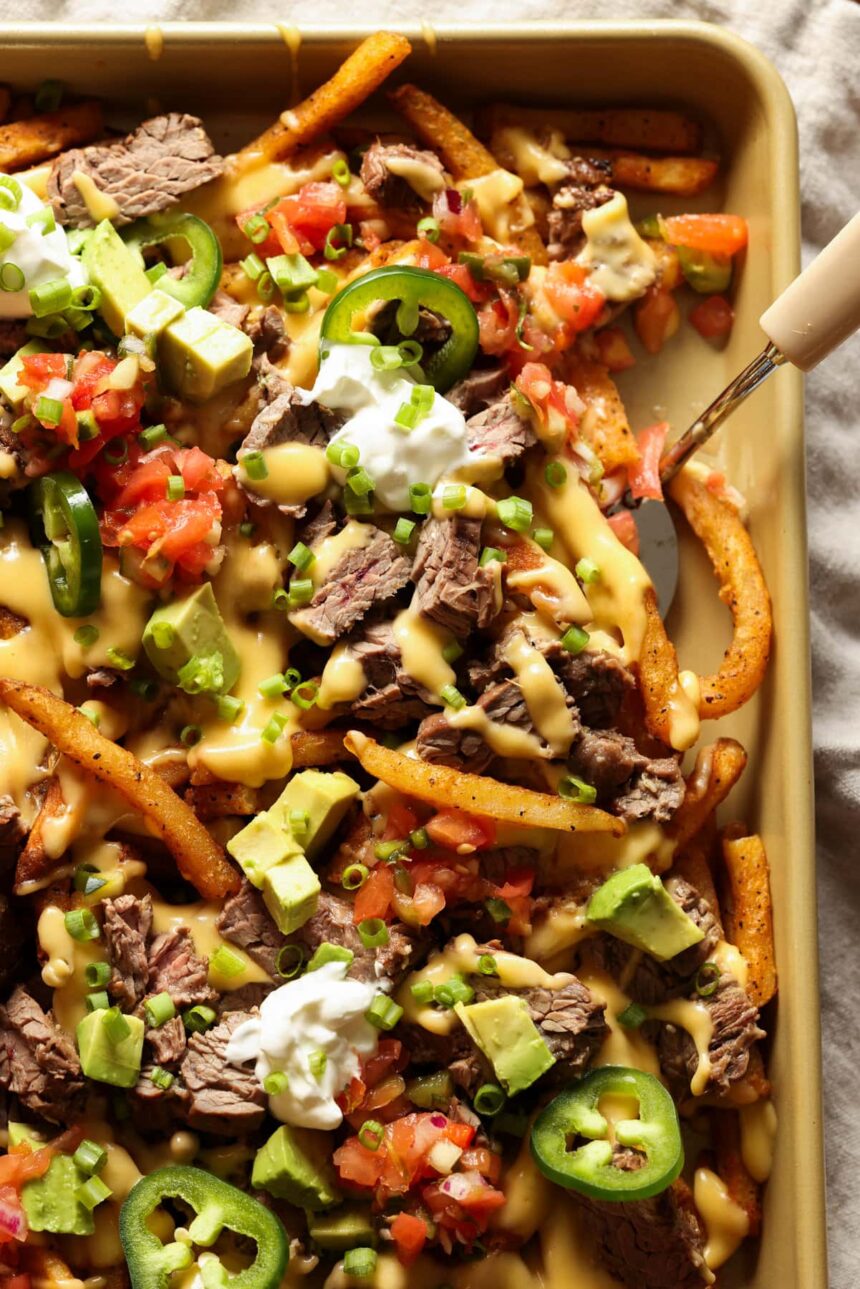 Carne Asada topped french fries with melted cheese and all the nacho toppings.