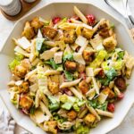 Chicken caesar pasta salad in a large bowl.