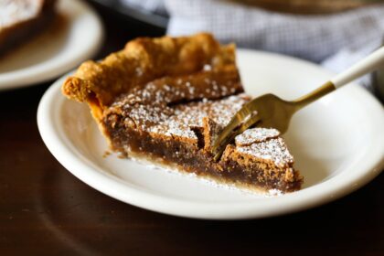 a fork taking a bite of chocolate chess pie