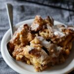 a piece of Cinnamon Roll Dump Cake on a plate with a fork