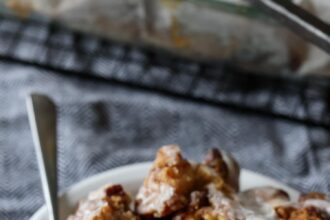 a piece of Cinnamon Roll Dump Cake on a plate with a fork