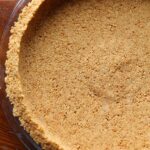 Graham cracker pie crust in a pie pan.