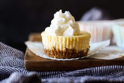 Mini cheesecake topped with whipped cream.