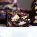 Cut brownies on a platter with pie crust baked inside