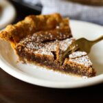 a fork taking a bite of chocolate chess pie