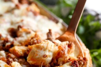 Unstuffed Shells pasta casserole with a spoon and melty cheese