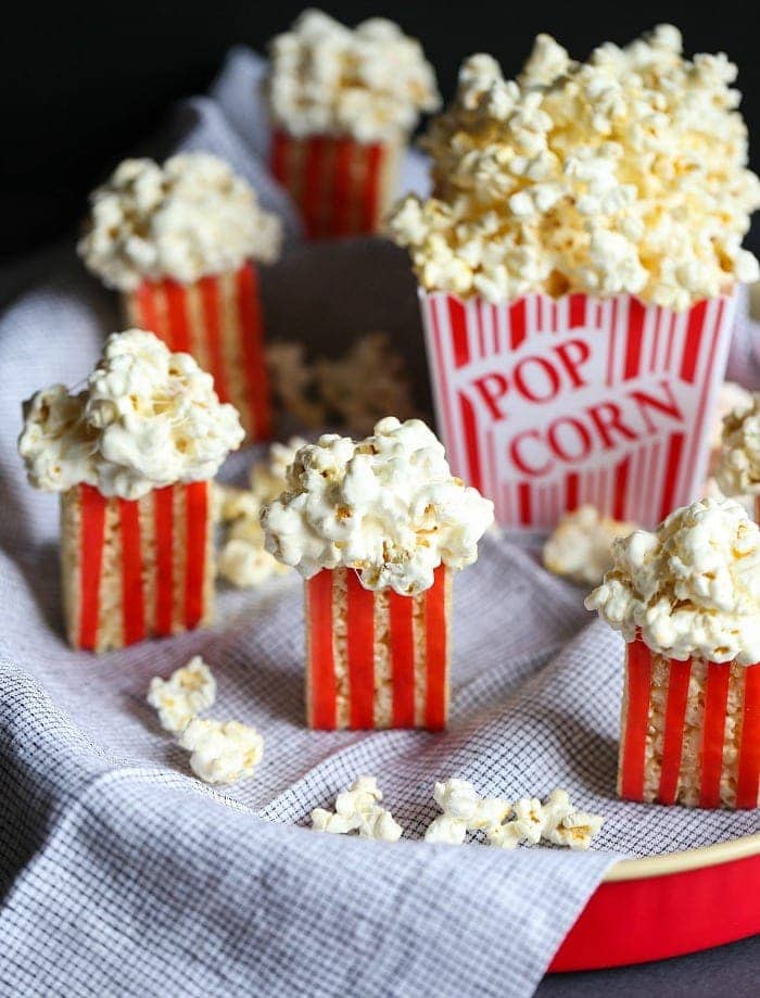 Rice krispie treats movie popcorn snacks around a box of popcorn.