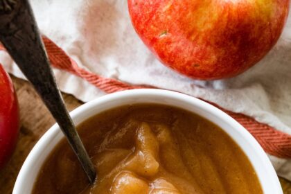 Homemade applesauce in a bowl with a metal spoon.