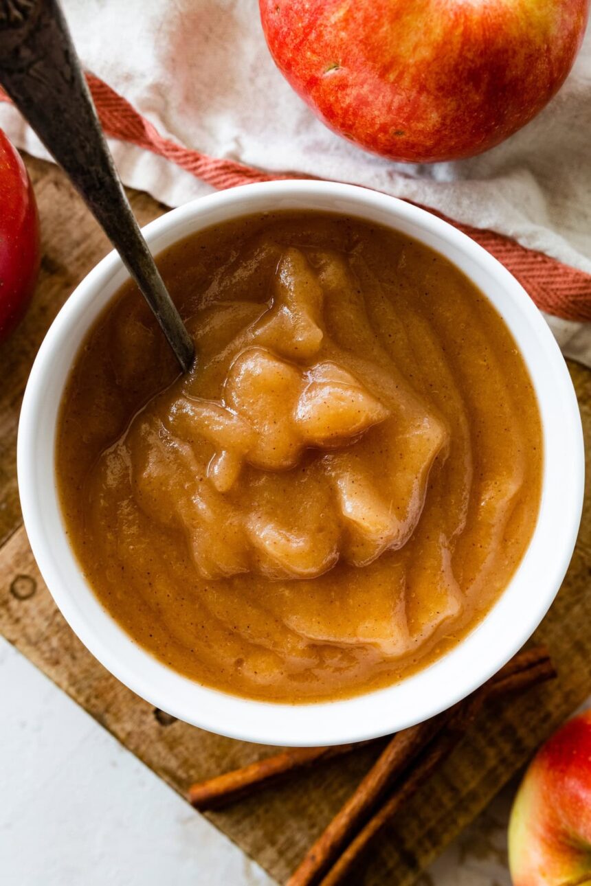 Homemade applesauce in a bowl with a metal spoon.