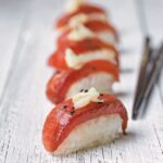 Cutting watermelon tuna sushi serving in wood plate