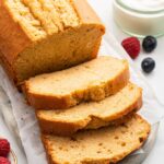 A french yogurt cake loaf with three slices leaning on one another near the loaf.