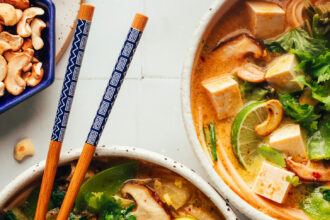 Two bowls of our cozy Thai-inspired curry noodle soup — one with chicken and one with tofu