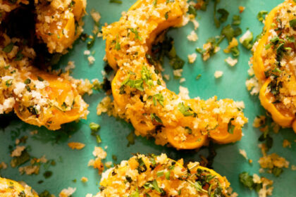 Close up photo of roasted delicata squash coated a garlic & herb breading