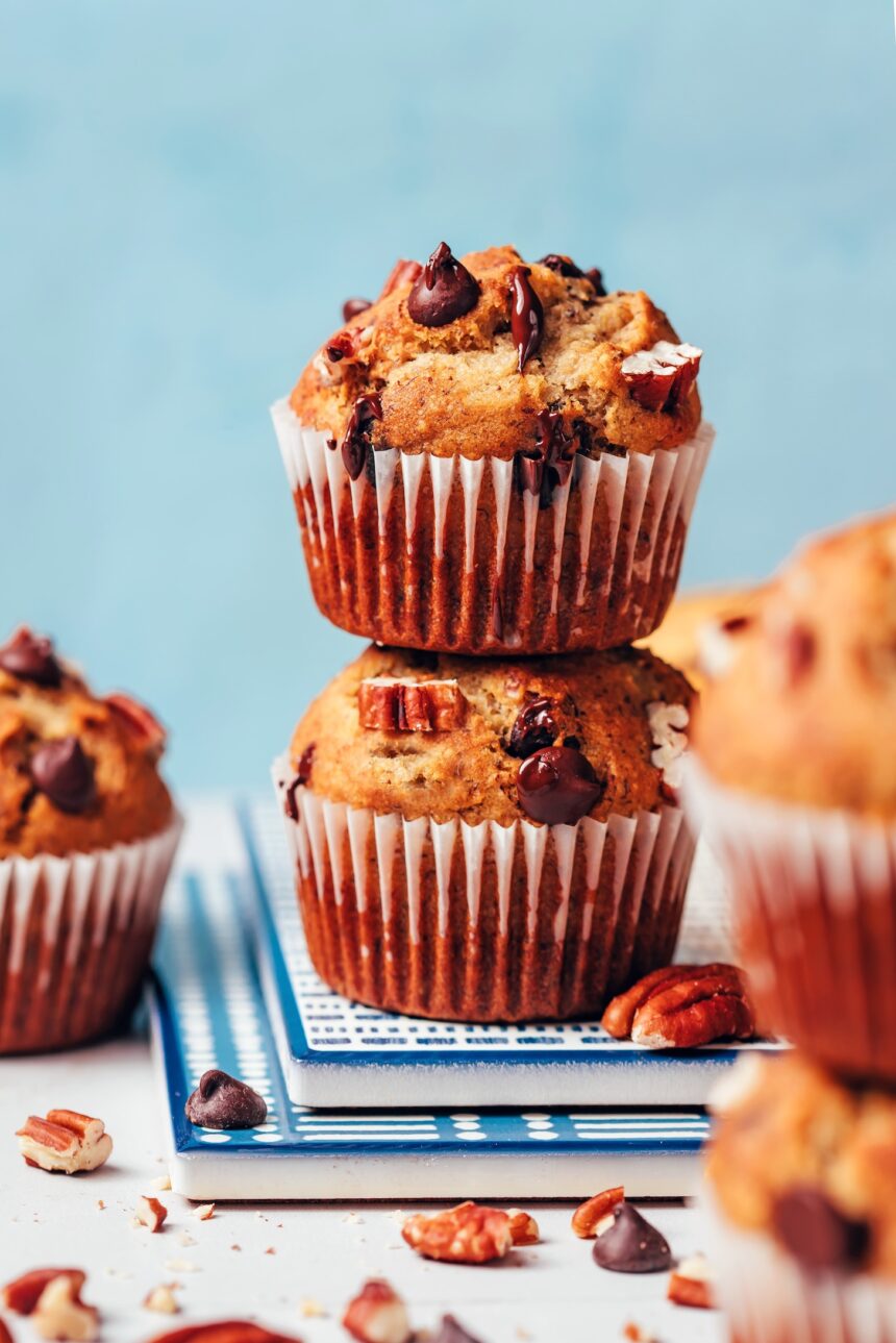 Stack of vegan gluten-free banana chocolate chip muffins dripping with melty chocolate