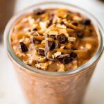 One glass jar filled with samoas overnight oats. It