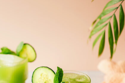 Glasses of cucumber lime agua fresca with cucumber slices on the rims and garnished with fresh mint