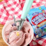 bubble gum ice cream in a bowl with a scoop