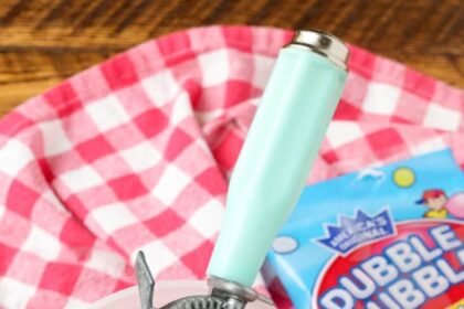 bubble gum ice cream in a bowl with a scoop