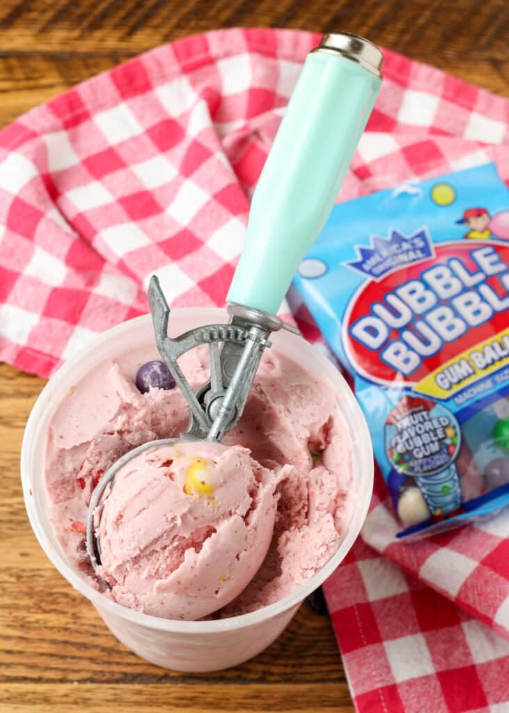 bubble gum ice cream in a bowl with a scoop