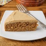 coffee cake with coffee frosting on a plate with a fork