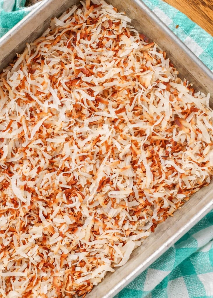 toasted coconut in pan over light blue napkin