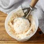 close up of coconut ice cream with wooden scoop