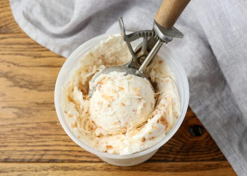 close up of coconut ice cream with wooden scoop