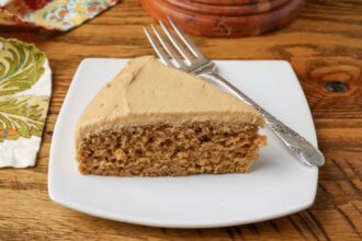 coffee cake with coffee frosting on a plate with a fork