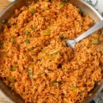 overhead horizontal photo of cajun rice in stainless skillet
