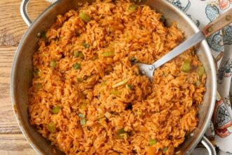 overhead horizontal photo of cajun rice in stainless skillet