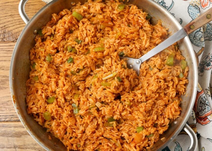 overhead horizontal photo of cajun rice in stainless skillet