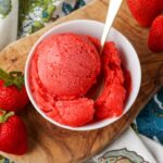 overhead shot of sorbet with strawberries on cutting board