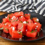 watermelon basil salad on a black plate