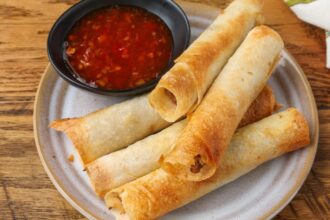 air fried lumpia on small plate with dipping sauce