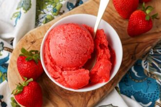 overhead shot of sorbet with strawberries on cutting board