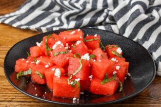 watermelon basil salad on a black plate