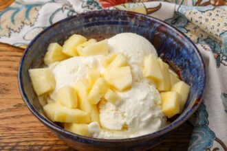 horizontal photo of ice cream with pineapple in a blue bowl