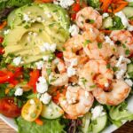 salad with avocado and shrimp on white platter