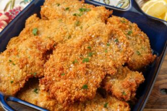 close up of fried pork cutlets in blue dish