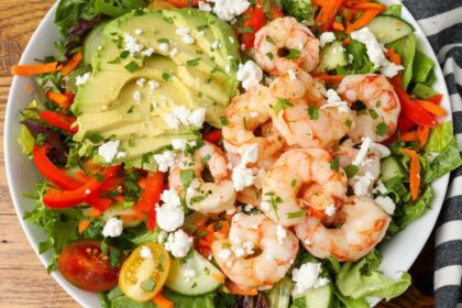 salad with avocado and shrimp on white platter