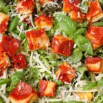 close up horizontal photo of salad with pizza croutons